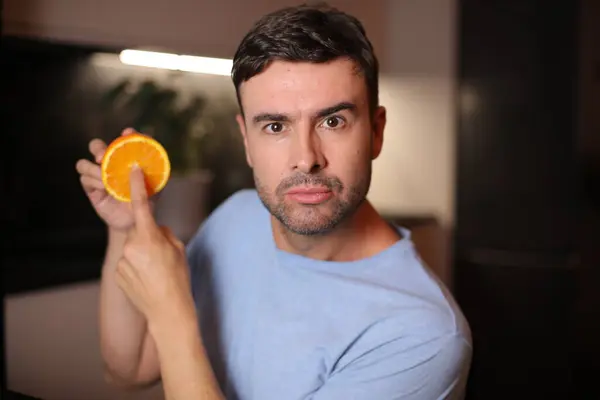 stock image Man showing the interior of orange fruit