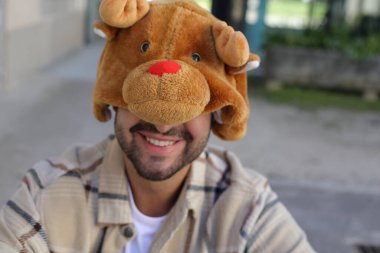 Man wearing a hat that imitates a bear face clipart