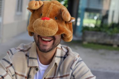 Man wearing a hat that imitates a bear face clipart
