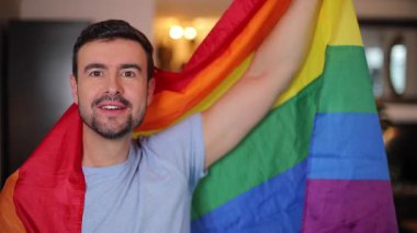 Gökkuşağı bayrağını sallayan yakışıklı, gururlu adam. 