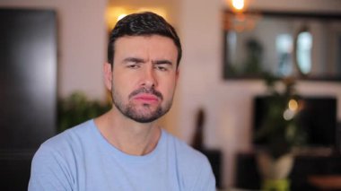 Odada sakallı yakışıklı bir adam var.