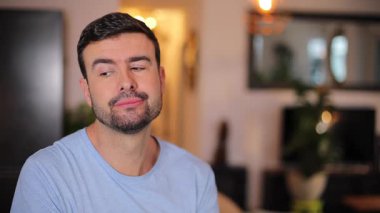 Odada sakallı yakışıklı bir adam var.