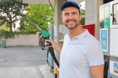 Genç İspanyol üniformalı adam istasyonda mutlu bir şekilde gülümsüyor..