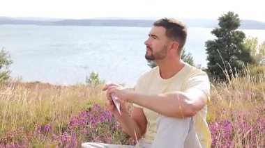 Buğday tarlasında defteri olan mutlu adam, yaz günü.