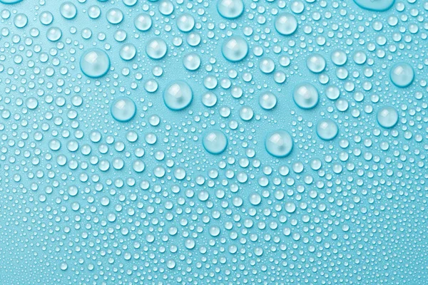 Water Druppels Een Blauwe Achtergrond Close — Stockfoto