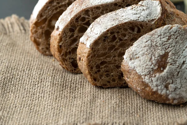 stock image Sourdough bread with crispy crust on wooden shelf. Bakery goods