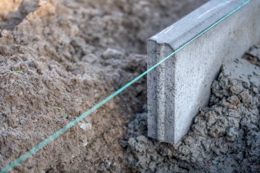 Bir yol inşaatında beton kaldırım kurulumu ve kurulumuna yakın çekim