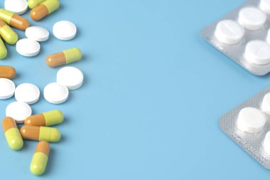 Mavi arka planda bir sürü ilaç var. Hastalıkların tedavisi için ilaç