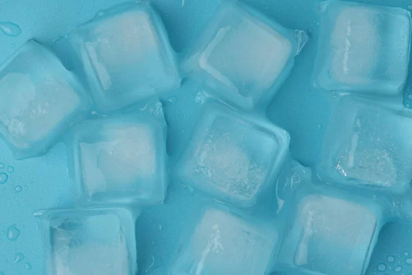 ice cubes with water drops close-up on a blue background