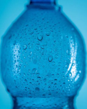 Su damlaları mavi arka planda, yakın planda.