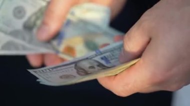 Hundred Dollar Cash Macro Motion. Background sign of the U.S. Fiat money bill. Hundred dollar cash close-up. Texture of hundred dollar bills. Concept Finance Business Investment.