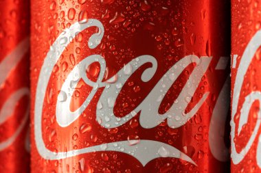 Ukraine, Kiev - January 19, 2023: Cold can of Coca-Cola drink on blue background with water drops