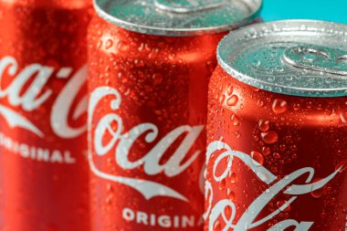 Ukraine, Kiev - January 19, 2023: Cold can of Coca-Cola drink on blue background with water drops