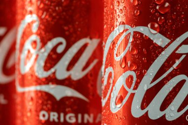 Ukraine, Kiev - January 19, 2023: Cold can of Coca-Cola drink on blue background with water drops