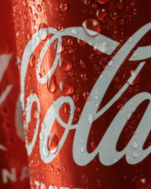 Ukraine, Kiev - January 19, 2023: Cold can of Coca-Cola drink on blue background with water drops