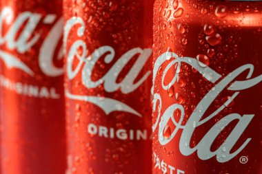 Ukraine, Kiev - January 19, 2023: Cold can of Coca-Cola drink on blue background with water drops