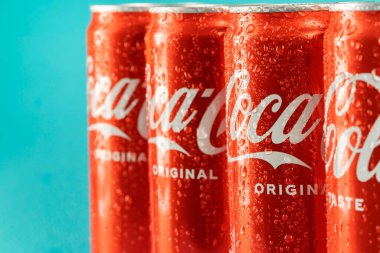 Ukraine, Kiev - January 19, 2023: Cold can of Coca-Cola drink on blue background with water drops