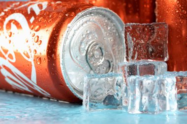 Ukraine, Kiev - January 19, 2023: Cold can of Coca-Cola drink on blue background with water drops