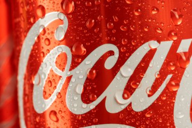 Ukraine, Kiev - January 19, 2023: Cold can of Coca-Cola drink on blue background with water drops