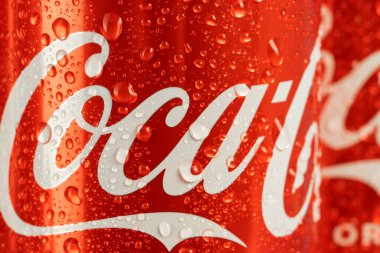 Ukraine, Kiev - January 19, 2023: Cold can of Coca-Cola drink on blue background with water drops