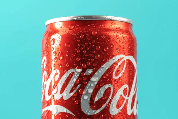 Ukraine, Kiev - January 19, 2023: Cold can of Coca-Cola drink on blue background with water drops