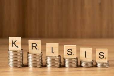 The word INFLATION on wooden cubes on a wooden background in the idea for the FED to consider raising interest rates, the world economy and the fight against inflation, U.S. dollar inflation