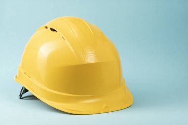 Construction helmet yellow on a blue background. Construction concept