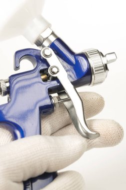 blue color paint gun on a white background close-up