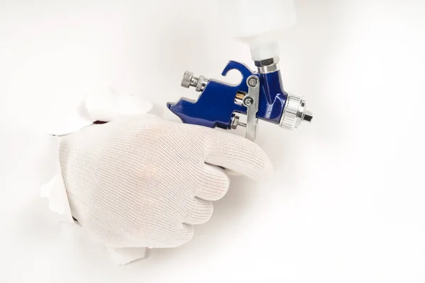 blue color paint gun on a white background close-up