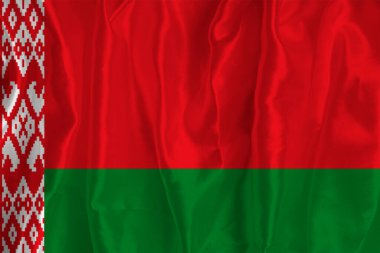 The flag of Belarus on a silk background is a great national symbol. Fabric texture The official state symbol of the country.