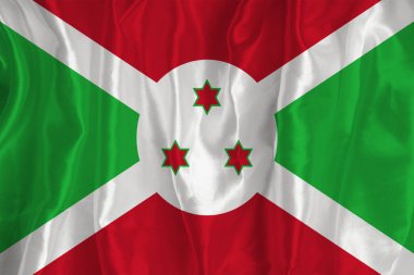 The flag of Burundi on a silk background is a great national symbol. Fabric texture The official state symbol of the country.