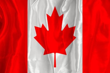 The flag of Canada on a silk background is a great national symbol. Fabric texture The official state symbol of the country.