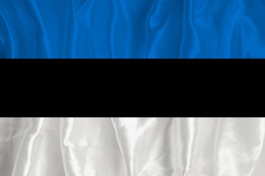 The flag of Estonia on a silk background is a great national symbol. Fabric texture The official state symbol of the country.
