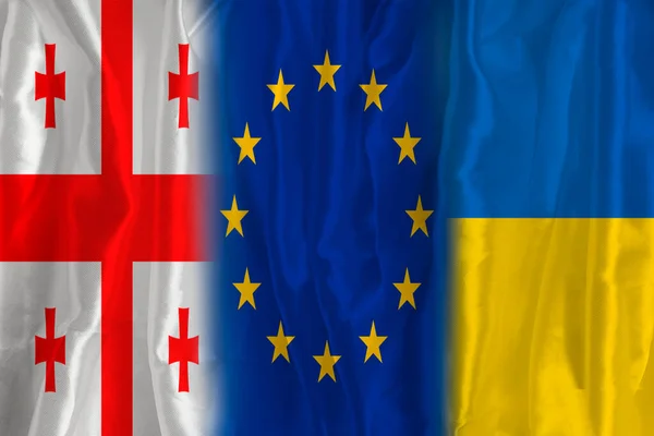 Georgian flag and EU flag. Flag of the country of Georgia and the European Union together. Conceptual image of Georgia and the European Union.