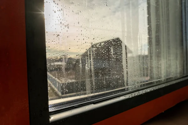 Close up of double glazed window condensation causes by excessive moisture in the house in winter occurs when the seal between panes is broken or desiccant inside the window.