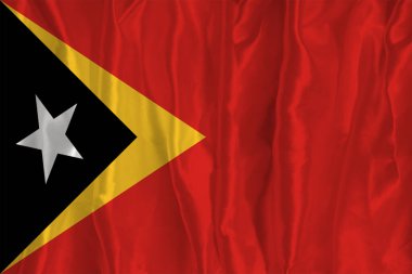 İpek arka planda Timor-Leste bayrağı büyük bir ulusal semboldür. Kumaş dokusu Ülkenin resmi devlet sembolü