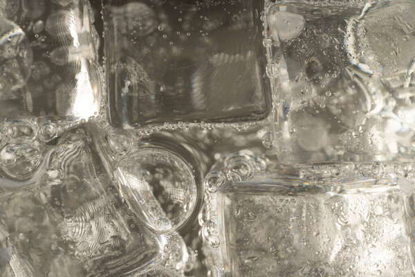 Ice cubes in soda. Ice water closeup