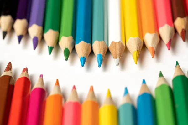 stock image Colored pencils lie in a row. A line drawn with pencil tips. Set of crayons for illustrations, art, study. Ready for school.