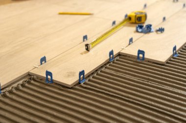 Tamir ve inşaat. Yere çimento döşeyerek seramik fayanslar seriyorum..