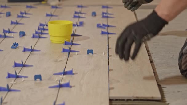 铁匠把地砖铺在地板上 厨房里的瓷砖一个耕作者正在把瓷砖粘在厨房地板上 一个男人在浴室地板上铺瓷砖 — 图库视频影像