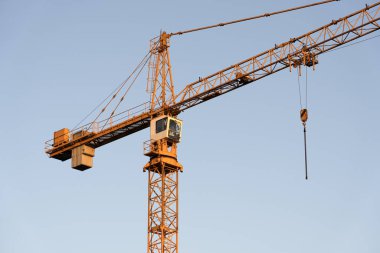 İnşaat alanı ve şehir arka planında kule vinçleri