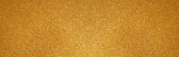 Gold glitter texture sparkling paper background. Abstract banner with twinkled golden glittering. Defocused lights for Christmas holiday. Flat lay mockup design.