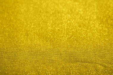 Parlak altın noktalı sarı doku. Merkeze odaklan ve iki ucunu da bulanıklaştır. Düz döşeme tasarımı. Doku sayfası soyut arkaplan, sarma dokusu.