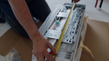 Air conditioning repair. A man with a screwdriver at the air conditioner. Maintenance of domestic air conditioners. High quality FullHD footage