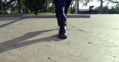 Bireysel yürüyüşün yakın çekimi, aşağıdaki karmaşık gölgeleri ve asfaltlı yüzeyin detaylarını gözler önüne seriyor.