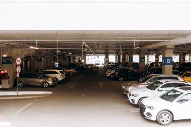 A large parking garage with diverse vehicles, featuring an organized, modern structure and various conveniences