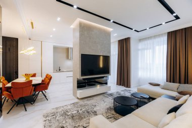 This stylish living room has cozy seating, modern decor, and a chic dining area perfect for entertaining