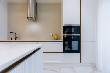 This stylish kitchen is showcasing a combination of modern design elements along with sleek, highend appliances