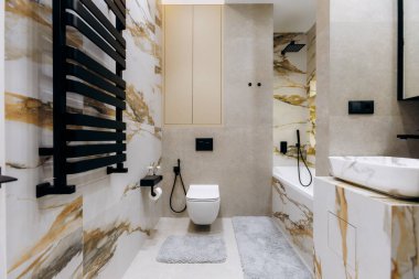 A stylish bathroom with luxury marble tiles, modern fixtures, and design elements that boost its appeal