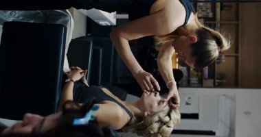 A skilled hairstylist works intricately on a clients beautiful hair in a stylish, chic salon environment